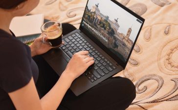 Female with laptop is searching for flights to Rome, Italy