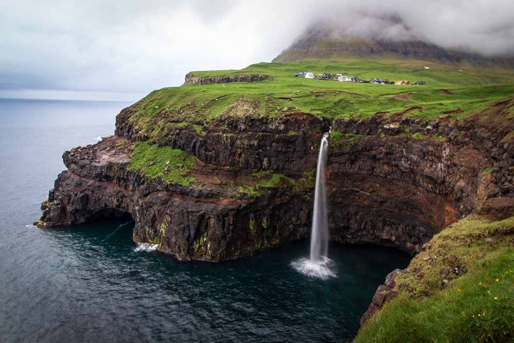 Fjords and the waterfall in Faroe Islands coastline
