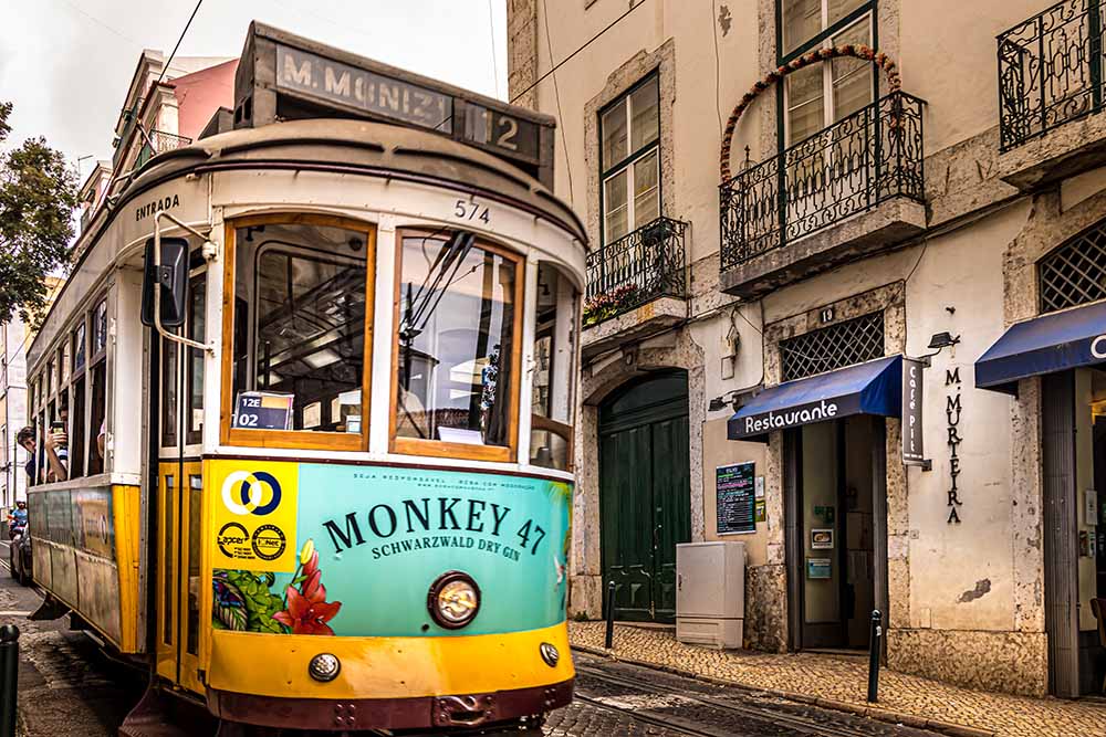 Tram in the street of Lisbon. Photo by Nextvoyage